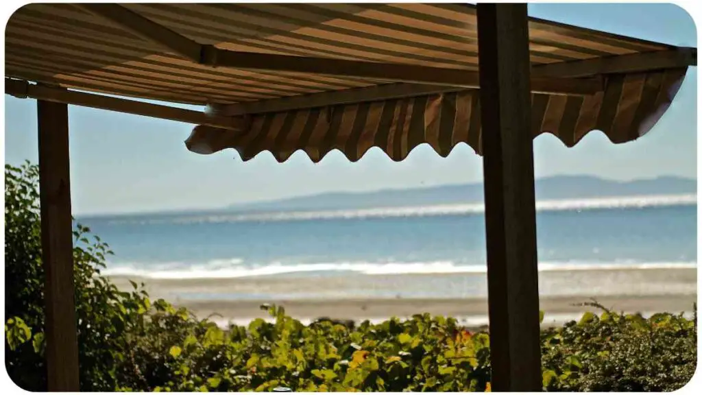 a view of the ocean from under an awning