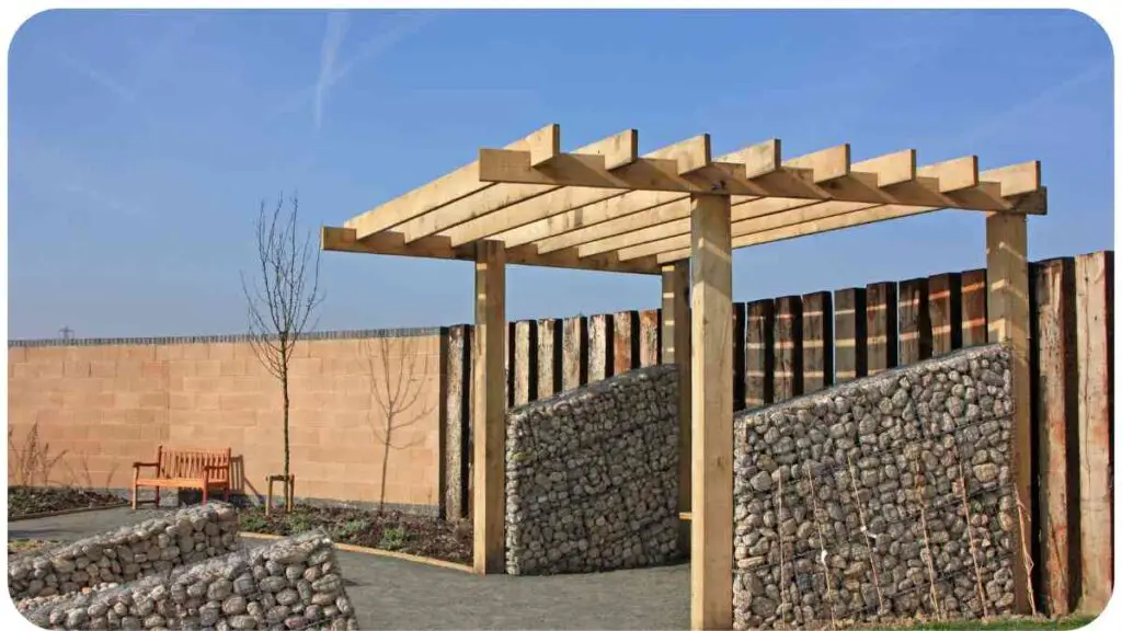 a stone wall with a wooden pergola and bench