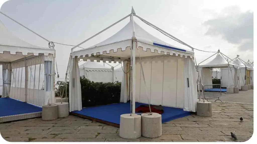 large white tent with blue carpet on the ground