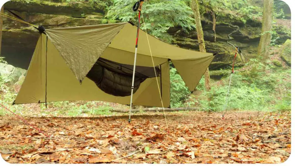 a tent in the woods with a hammock attached to it