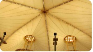 the inside of a tent with four windows and a ceiling