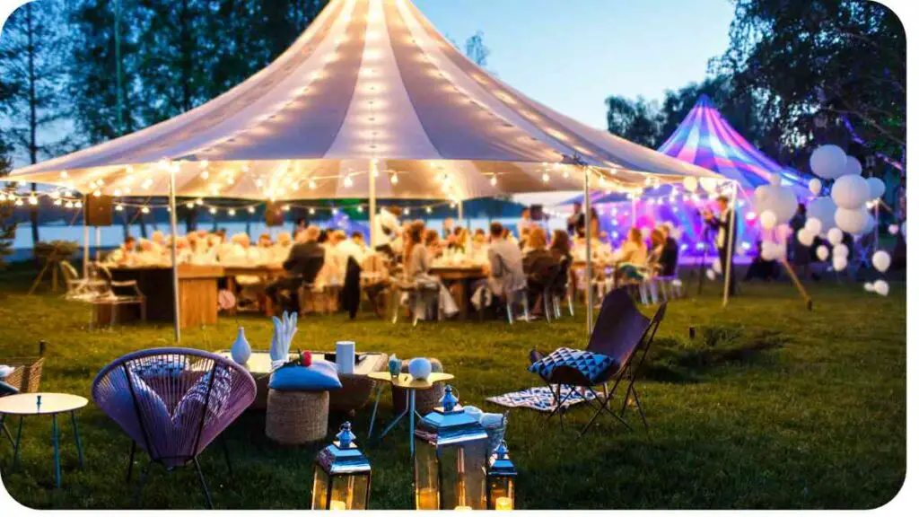 an outdoor wedding party under a tent with white lights