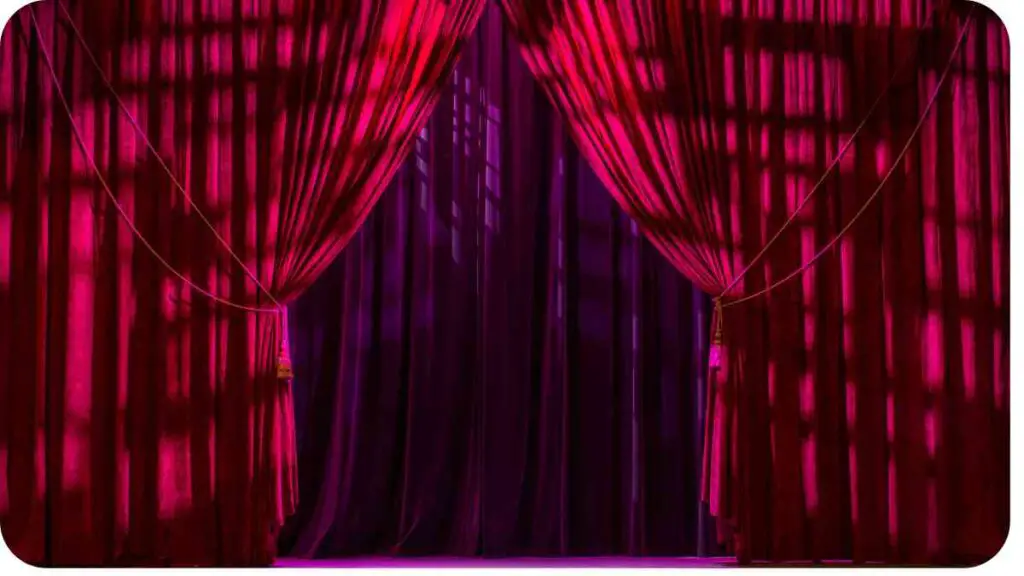 a red curtain is open in front of a stage