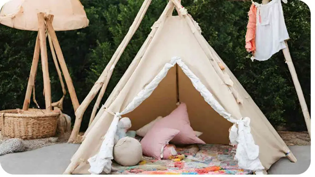 an outdoor teepee with pink and white pillows