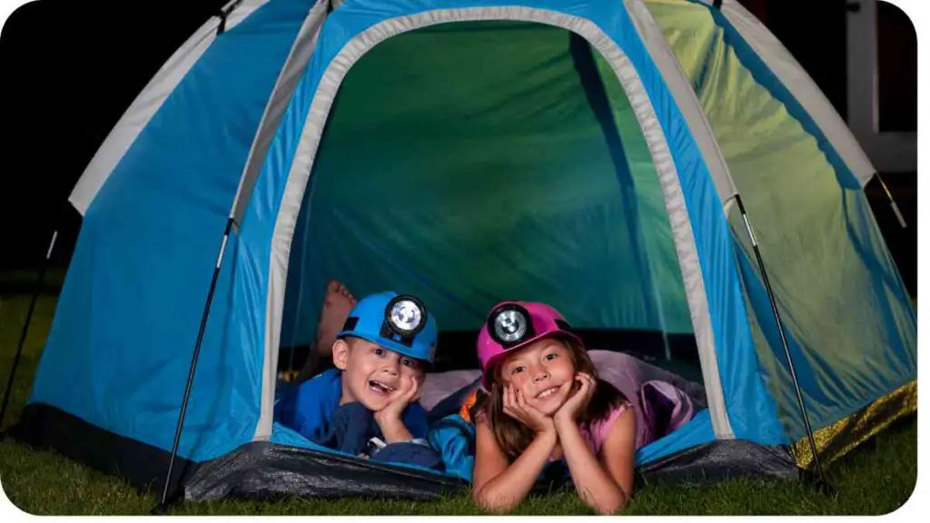 two children in a tent at night