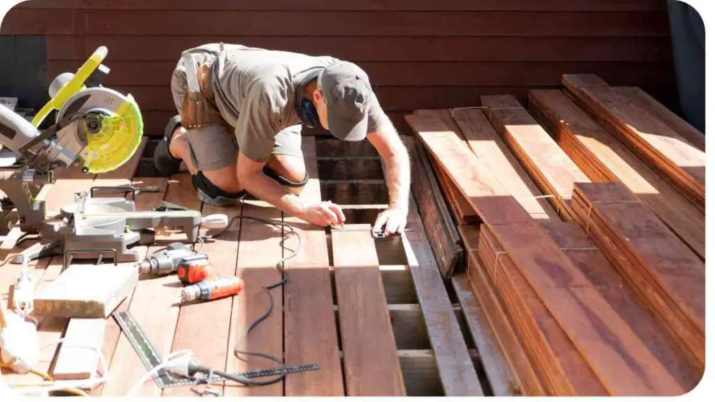 a person working on a wooden deck with tools