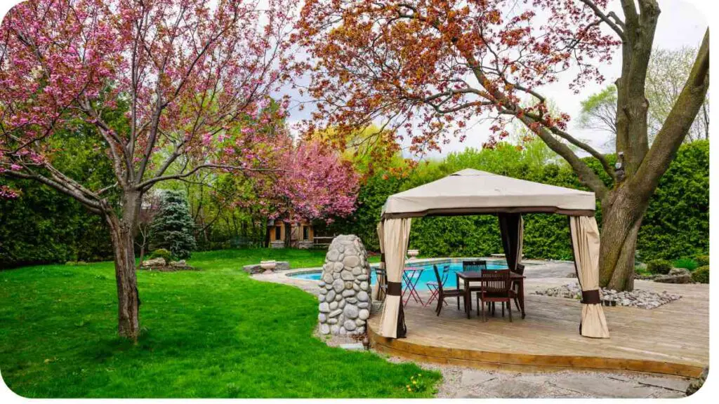 a gazebo with a table and chairs in front of a pool