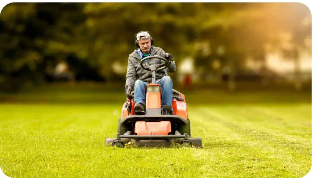 a person riding a lawn mower on a grassy field