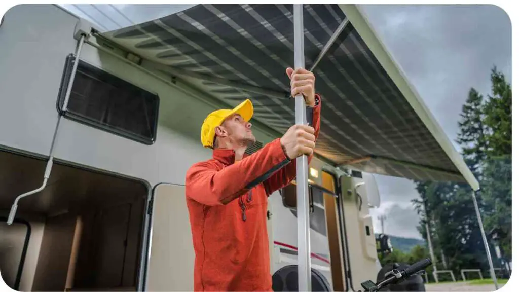 a person with a yellow hat is holding a pole in front of an rv