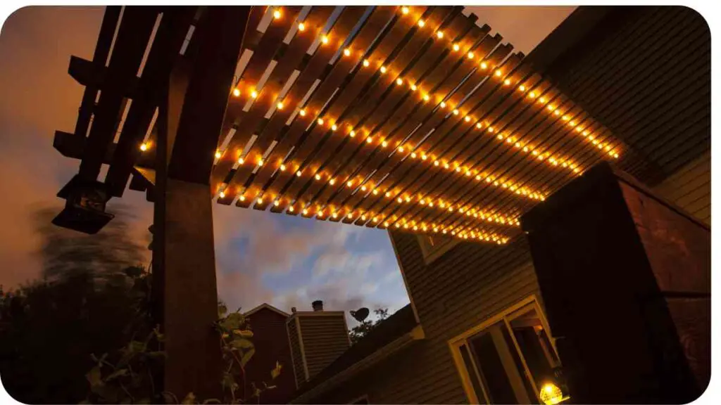 a wooden pergola with lights on it at night