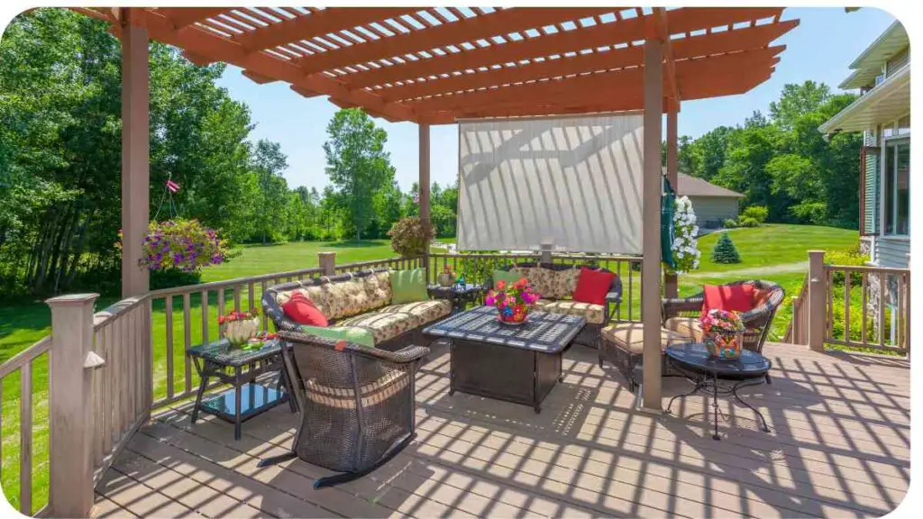 a deck with patio furniture and a pergolized awning