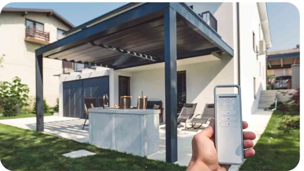 a person holding a remote control in front of a house