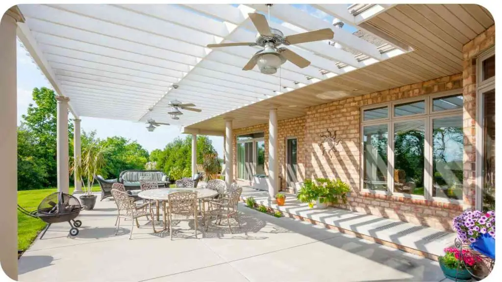 a patio with white pergola and patio furniture