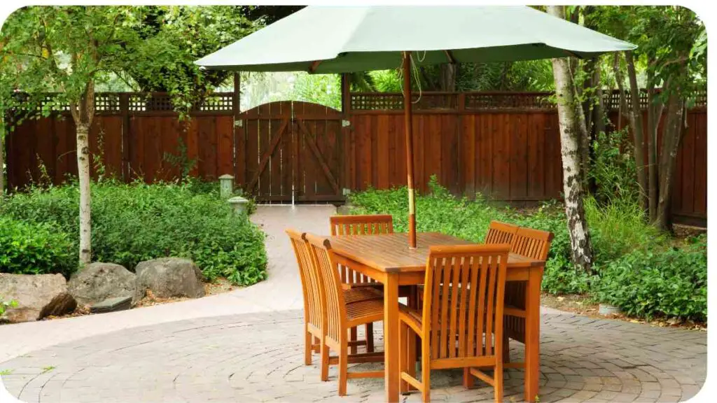 an outdoor dining table and chairs under an umbrella