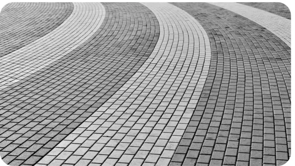 a black and white photo of a brick walkway