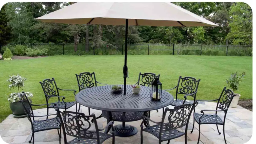 an outdoor dining table and chairs under an umbrella