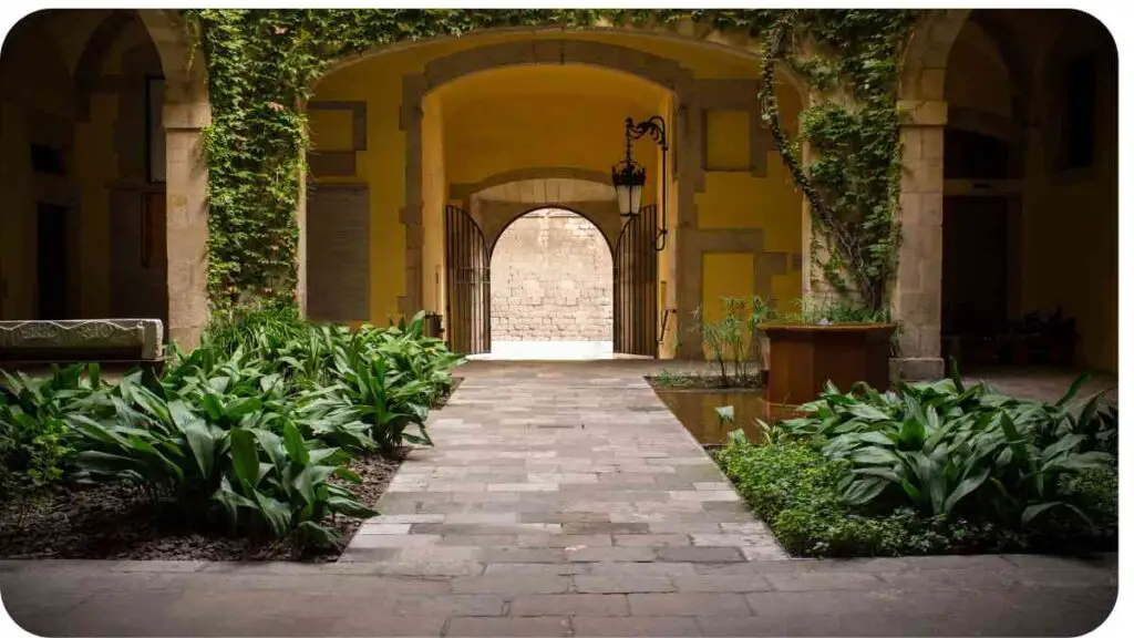 an archway leads to a courtyard with green plants