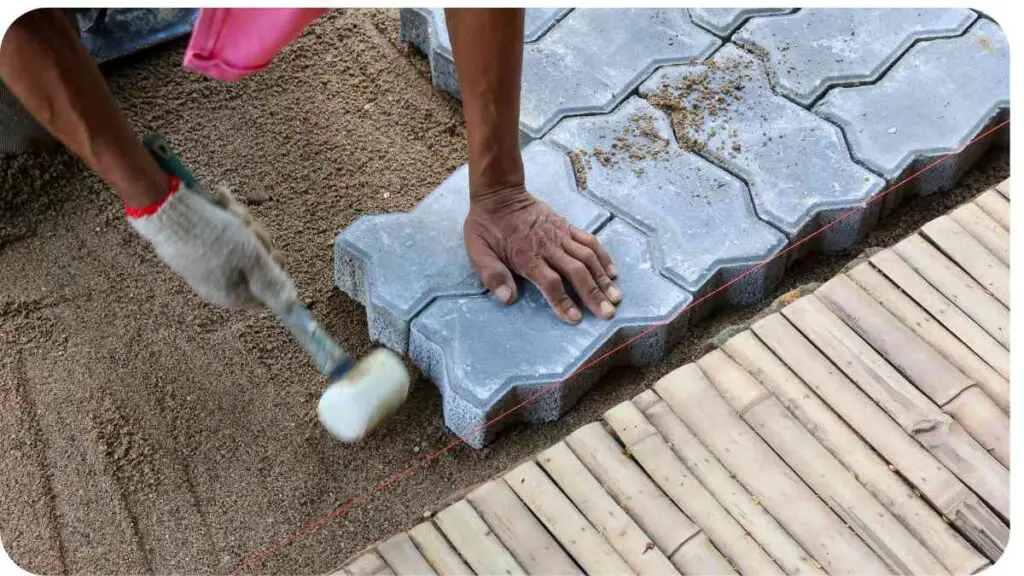 a person is laying bricks on the ground