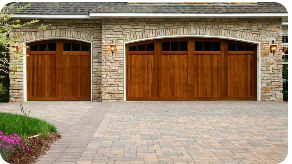 two wooden garage doors in front of a house